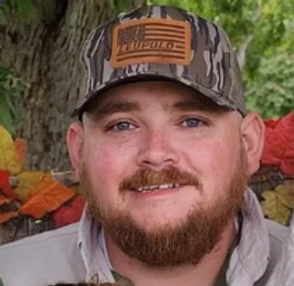 Animal Services Officer sitting in a corner and smiles for the camera
