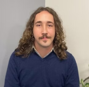 Animal Services Officer 1 seated quietly in a corner of the facility.